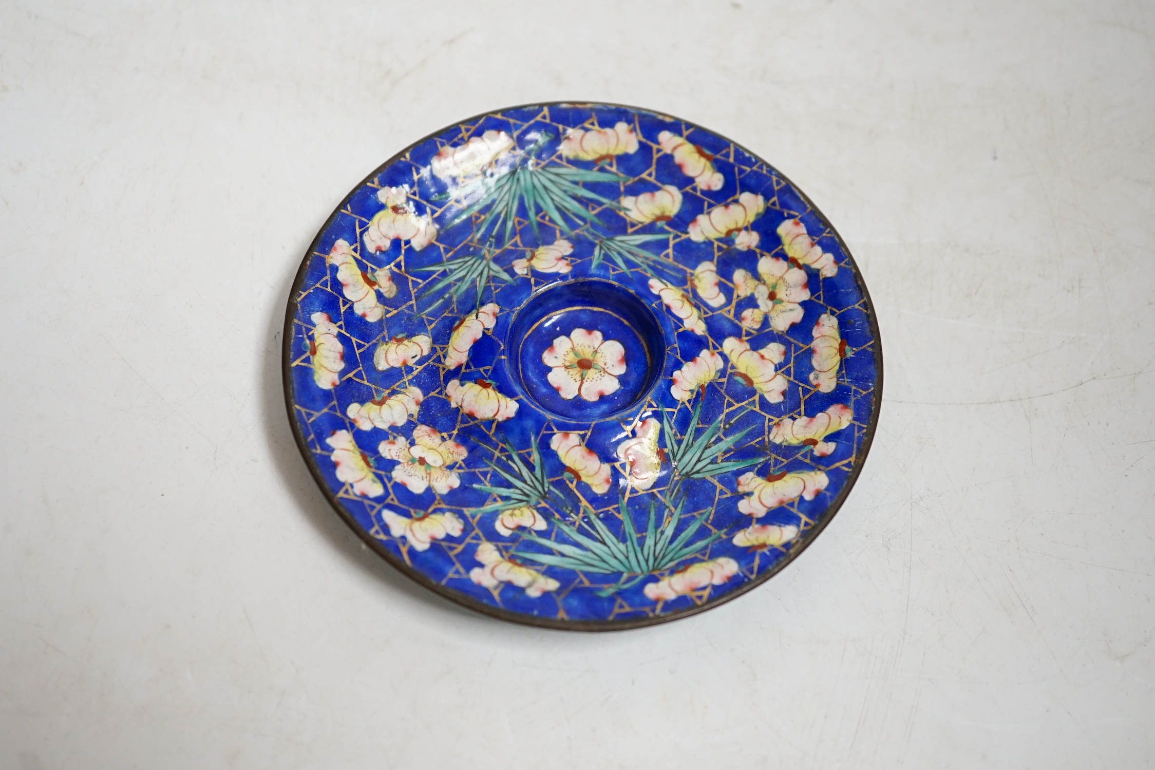 A 19th century Canton enamel tea bowl and stand, 11cm in diameter. Condition - saucer good, cup poor